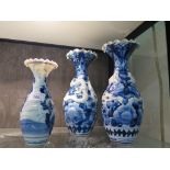 A pair of Japanese blue and white vases, with applied dragon decoration, and crimped rims 26cm