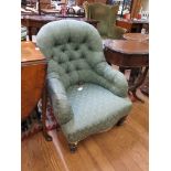 A Victorian button back upholstered armchair on turned tapering legs and pot castors