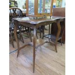 An Edwardian walnut window table with shaped top and cabriole legs joined by an undershelf 71cm wide