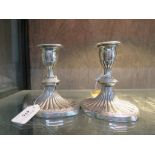 A pair of small Adam style silver plated candle sticks