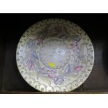 A Charlotte Rhead charger, the pink and blue flowers on a grey ground 31cm diameter