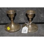 A pair of silver candlesticks with ribbed decoration 11cm tall, Birmingham 1910