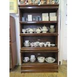 A Globe Wernicke Co. stacking bookcase, the four graduated tiers with glazed fall fronts over a