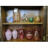 Two Guernsey pink spiral glass vases, three red Dartington glass vases, and a blue trail small vase,