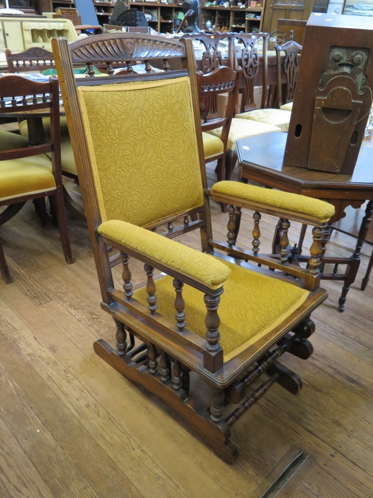 An Edwardian walnut rocking chair, with turned spindles