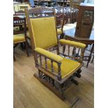 An Edwardian walnut rocking chair, with turned spindles