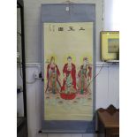 A Japanese scroll painting of three deities standing on lotus leaves, with stamp and inscription,