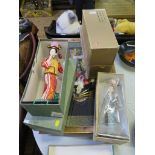 Five Japanese porcelain dolls, in their boxes, and a wall mounted Japanese porcelain figure