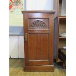 An Edwardian walnut bedside cabinet, with foliate carved and panelled door 41cm wide