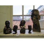 Five African hardwood carved busts, largest 31cm high