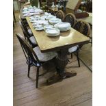 An oak refectory table with lobed baluster cup and cover supports 179cm x 66cm and six wheelback