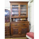 An Edwardian walnut secretaire bookcase, the top with twin glazed doors and mirrored back over a