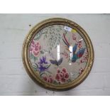 A silk circular embroidery depicting a bird and butterfly in flowers 29cm diameter