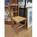 An Edwardian beech bedroom chair, with re-caned seat and turned legs