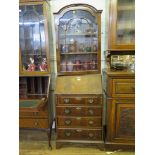 A reproduction crossbanded mahogany bureau bookcase, the arched glazed single door over a sloping