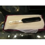 An Asprey miniature butter knife with mother of pearl handles in original box