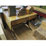 An early 19th century style mahogany sofa table, the ebony lined top over two frieze drawers on