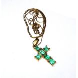 An emerald cross and neck chain set in yellow gold