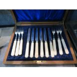 A set of tea knives and forks for six place settings in wooden box