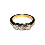 A three stone diamond ring set in 18 carat gold