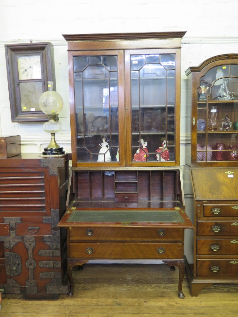 An Edwardian mahogany bureau bookcase, the pair of glazed doors over a quarter veneered slope and