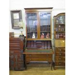 An Edwardian mahogany bureau bookcase, the pair of glazed doors over a quarter veneered slope and