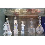 A Lladro figure of a mother and child 26cm high, two other Lladro figures, two Swarovski crystal