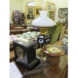 A slate mantel clock with inscribed dial and French movement, a small wall clock, and an oil lamp (