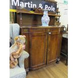 A Regency rosewood and brass inlaid chiffonier, the shaped raised back with shelf over a bowfront