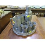A Swatow Yimkee pewter drinks set comprising cocktail shaker, six shot glasses and a tray, with