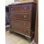 A mahogany and satinwood crossbanded chest of drawers, with four long drawers on ogee bracket