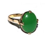 A 14 carat ring set with a cabochon jade stone