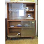 Two 'Multi-Width' teak cabinets with sliding glass doors, one on tapering legs 99cm wide