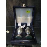 A silver salt and pepper in presentation case