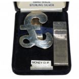 Two silver money clips, one being for the Millennium 2000