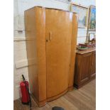 An Art Deco bird's eye maple gentleman's wardrobe, with bowed door and sides, 92cm wide 171cm high