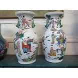 A pair of Chinese famille rose vases depicting figures in gardens 38.5cm high
