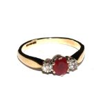 A three stone ruby and diamond ring set in 9 carat gold