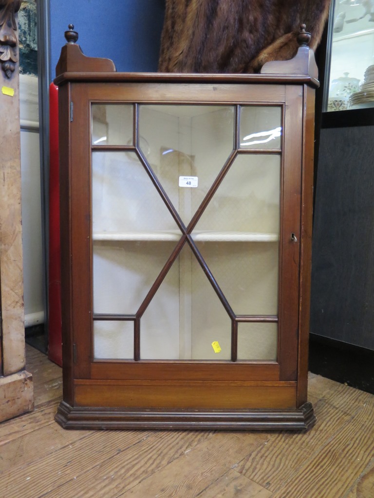 An Edwardian mahogany hanging corner cabinet, with astragal glazed door and turned pendants 56cm