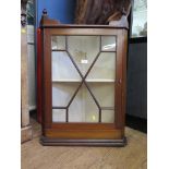 An Edwardian mahogany hanging corner cabinet, with astragal glazed door and turned pendants 56cm