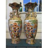 A pair of Japanese gilded vases, depicting Geisha girls within floral borders, 61cm high