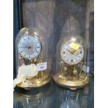 A glass domed anniversary clock, retailed by Prescott, and another anniversary clock (2)