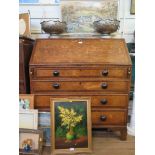 A 19th century crossbanded oak bureau, the sloping fall enclosing a fitted interior over four long