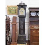 A late Victorian carved ebonised longcase clock, the arched engraved dial with silvered chapter,