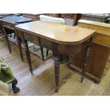 A Victorian mahogany foldover tea table, with tablet frieze on ring turned legs 91cm wide