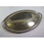 An late Victorian oval silver tray with ribbed border and inset handles, 56cm diameter, 47.5 troy