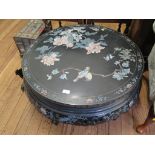 A Chinese lacquered circular coffee table, carved with birds and flowers on folding square