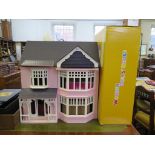A pink doll's house, in the Edwardian style, with doll family, nursery furniture, household