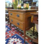 An Edwardian oak chest of drawers, with two long drawers on tapering square section legs 81cm wide