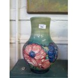 A large Moorcroft Pottery blue and green vase with floral decoration, painted initial and